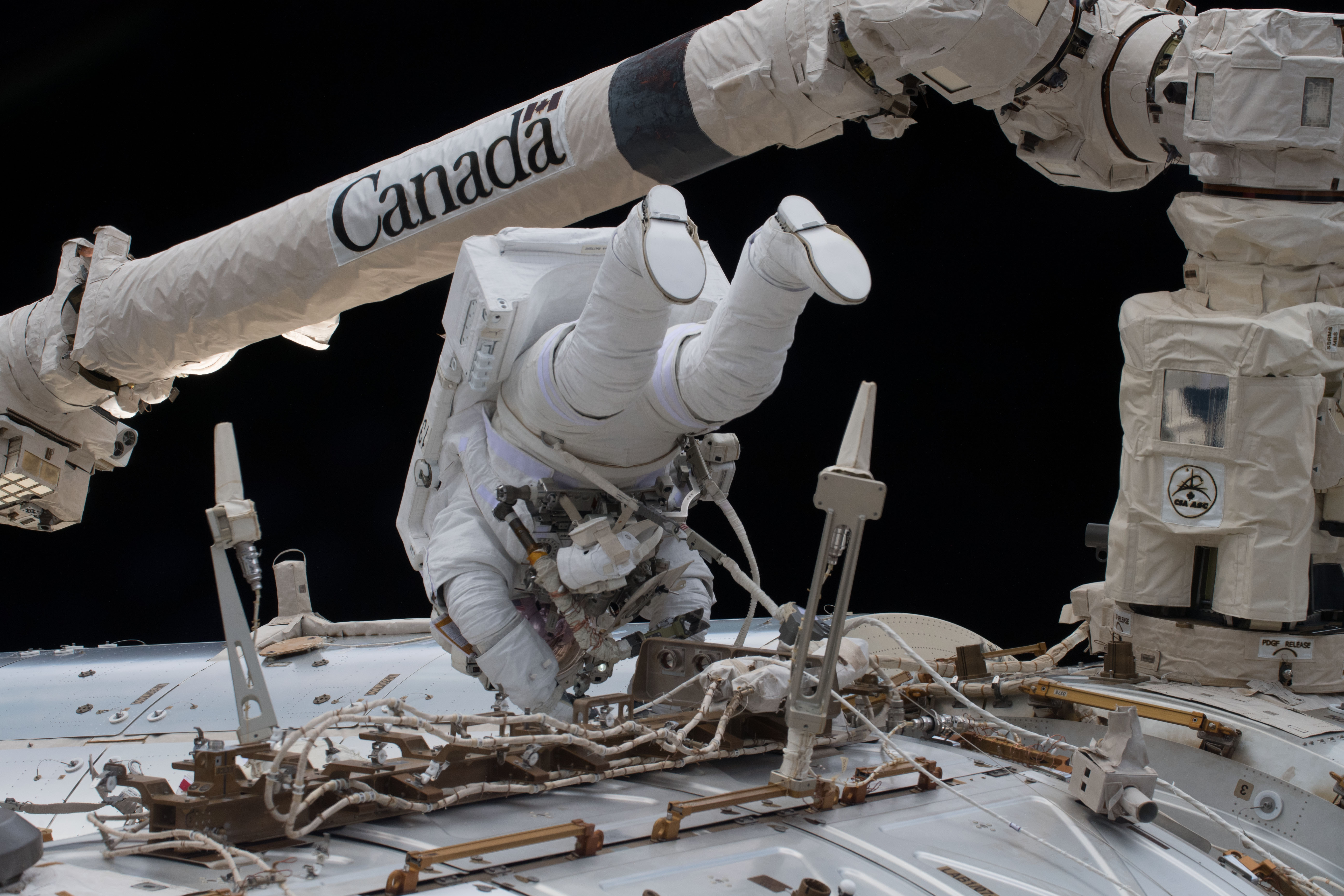 Astronaut EVA close-up with Canadarm2